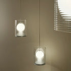 Two modern pendant lights with ribbed clear glass shades hanging at different heights, with a third light shade partially visible on the right.